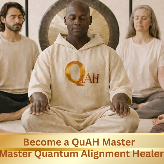 Group of people in a meditation session with a person in the center wearing a 'QuAH' hoodie.