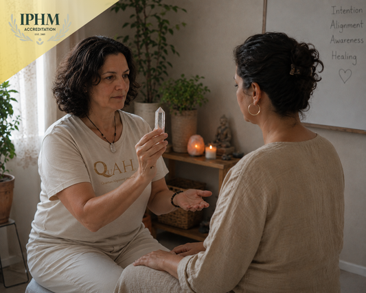Crystal healing training with a QuAH practitioner using clear quartz during a healing session.